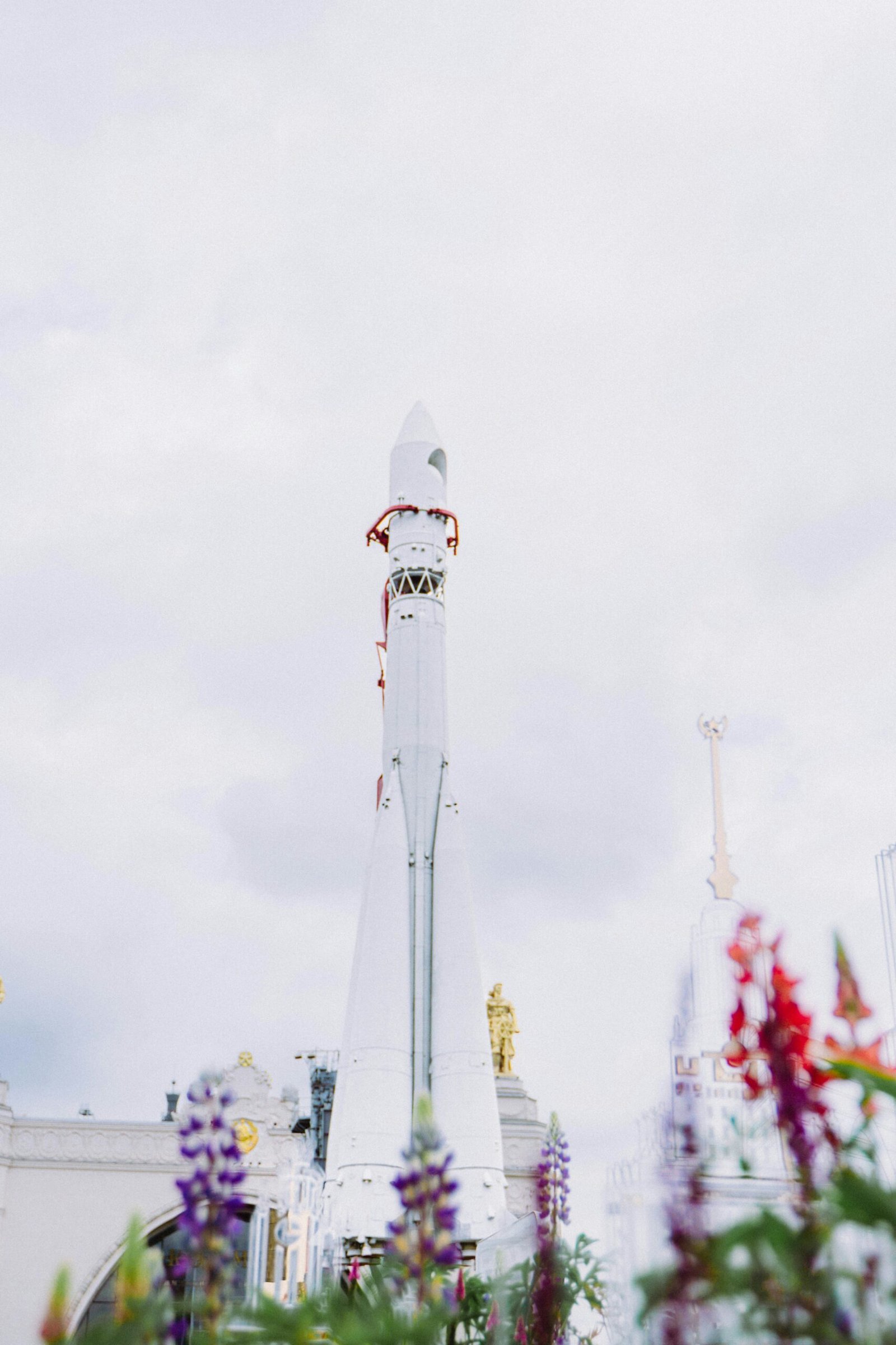 a tall white tower with a clock on it's side